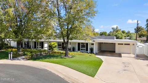 a front view of a house with a yard table and chairs
