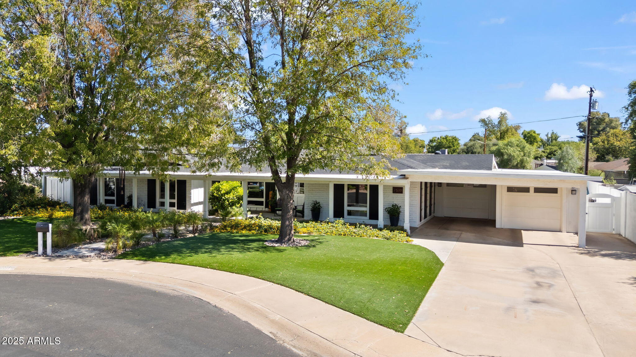 7519 North 12th Avenue Phoenix, AZ 85021 - Photo 4 of 52 a front view of a house with a yard table and chairs