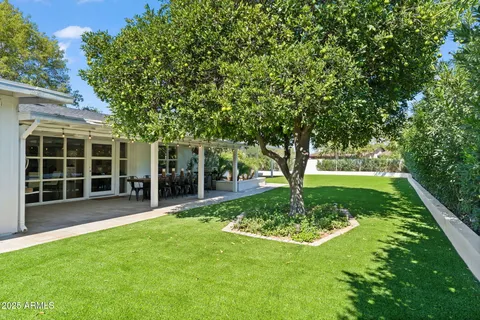 a view of a patio with table and chairs