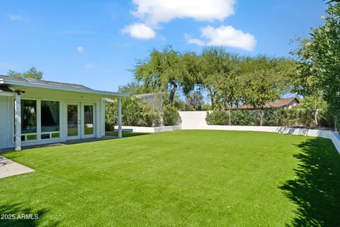 an aerial view of residential houses with outdoor space and swimming pool