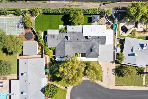 an aerial view of a house with a yard