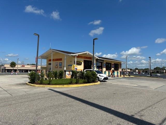 2700 North Pine Hills Road Orlando, FL 32808 - Photo 1 of 1 a front view of a building with sitting space