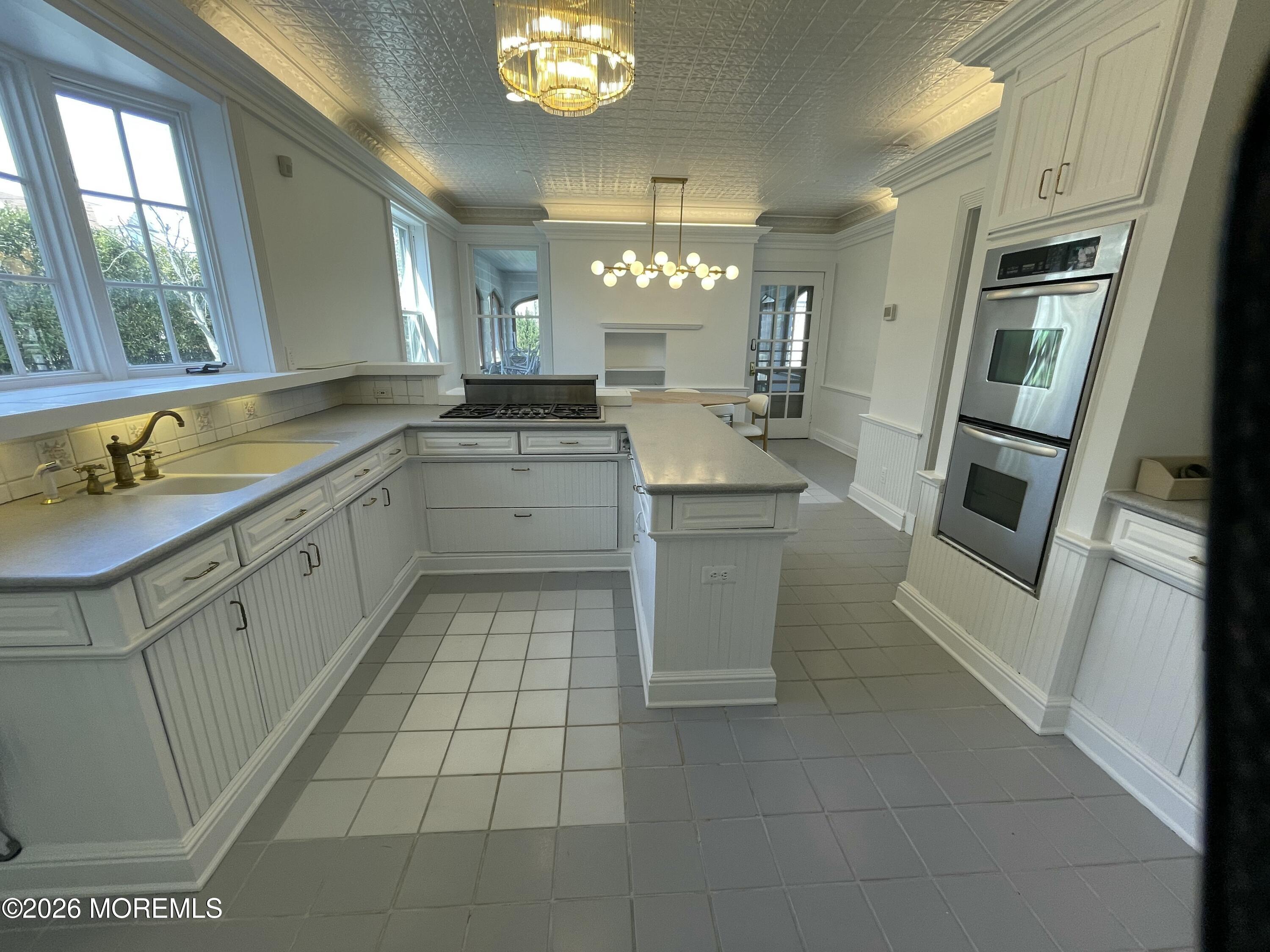 211 Cedar Avenue Allenhurst, NJ 07711 - Photo 13 of 20 a kitchen with a sink cabinets and stainless steel appliances