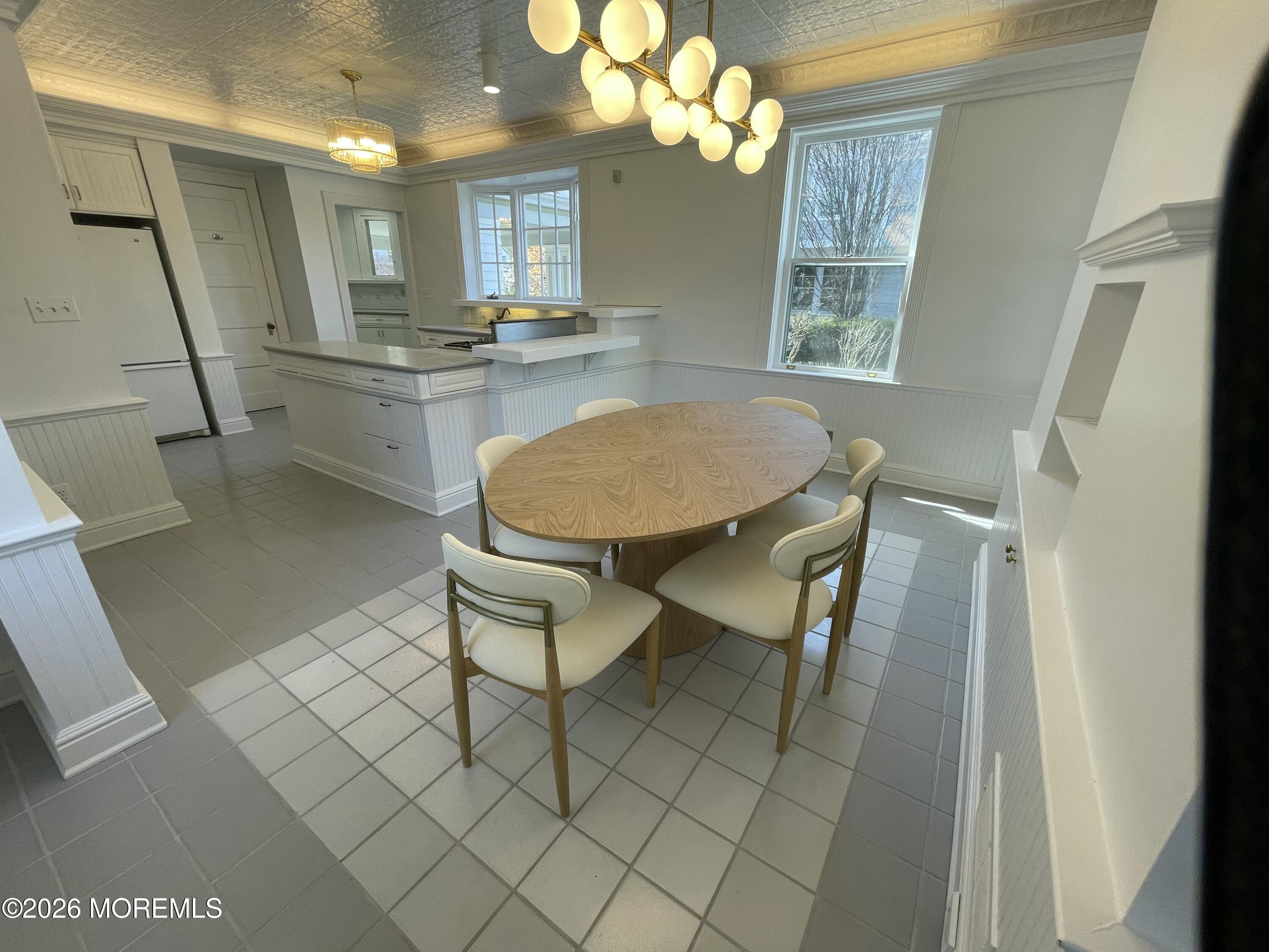 211 Cedar Avenue Allenhurst, NJ 07711 - Photo 16 of 20 a view of a dining room with furniture and a chandelier
