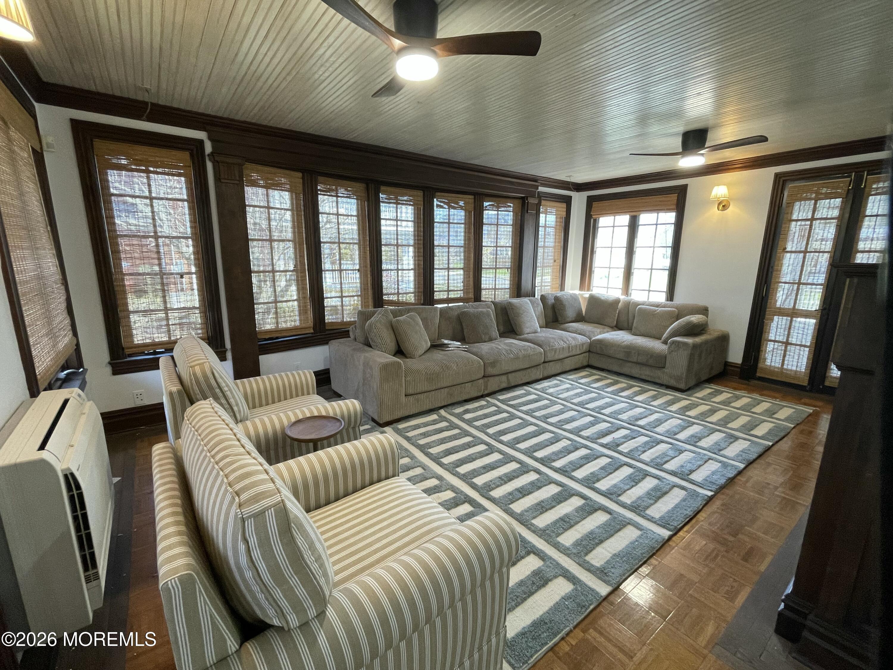 211 Cedar Avenue Allenhurst, NJ 07711 - Photo 7 of 20 a living room with furniture and a floor to ceiling window