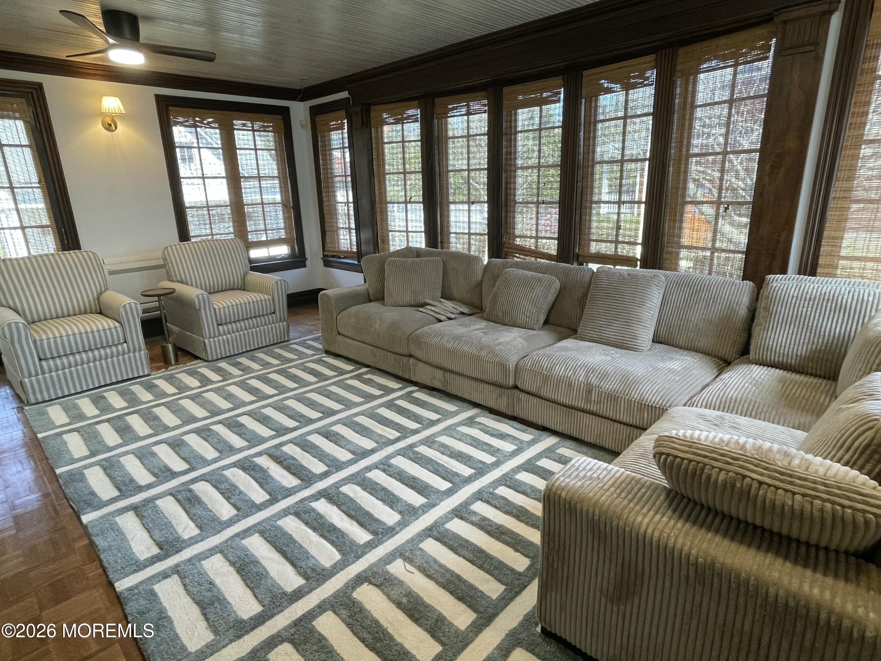 211 Cedar Avenue Allenhurst, NJ 07711 - Photo 8 of 20 a living room with furniture and a large window