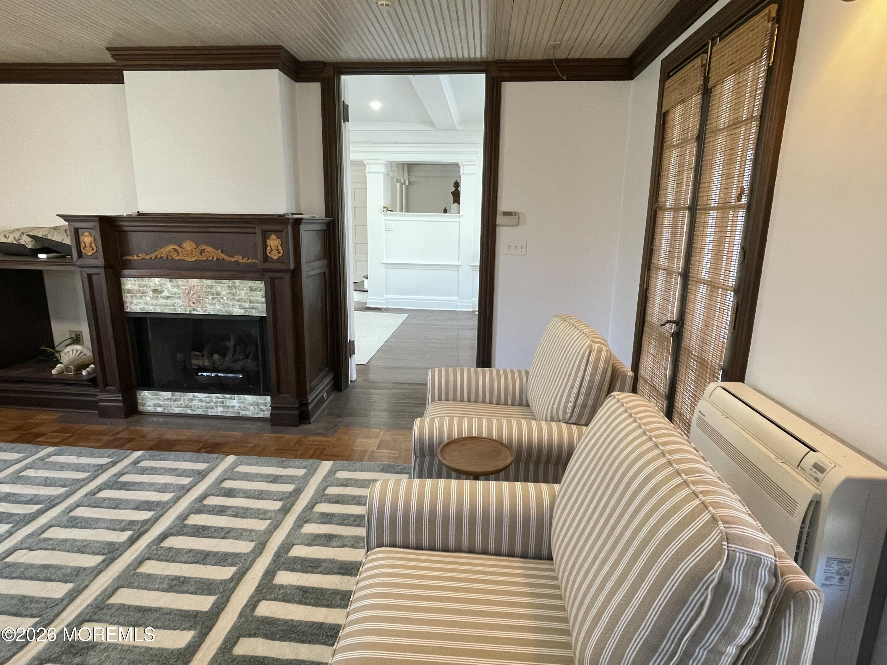 211 Cedar Avenue Allenhurst, NJ 07711 - Photo 9 of 20 a living room with furniture a flat screen tv and a fireplace