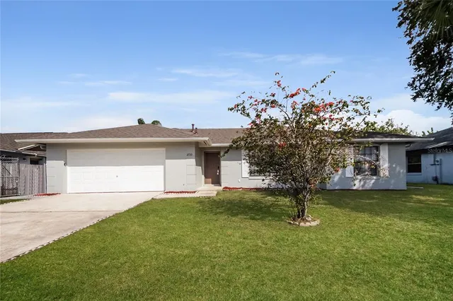 a view of a house with a yard and a garage