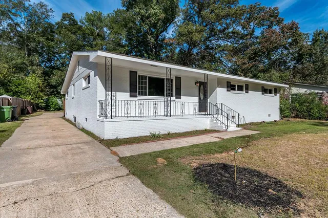 a house that has a tree in front of it