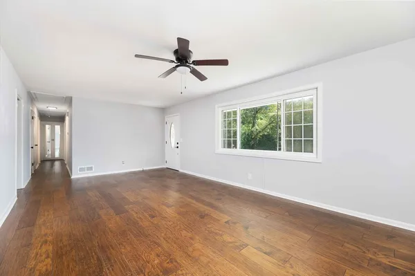 a kitchen with stainless steel appliances granite countertop wooden cabinets and a large window