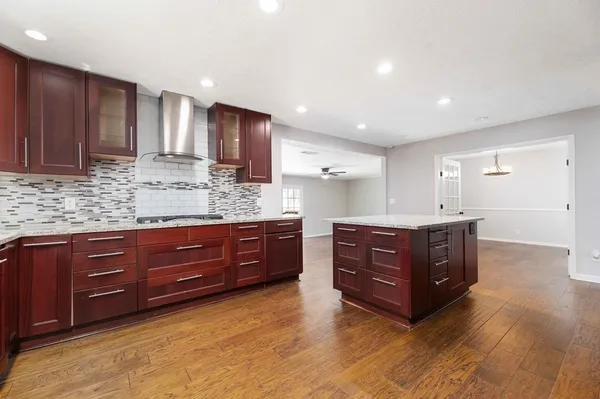 a kitchen with stainless steel appliances granite countertop wooden cabinets and granite counter tops