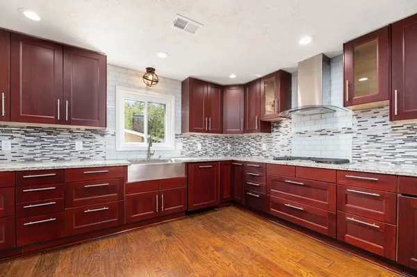 a kitchen with stainless steel appliances granite countertop wooden cabinets a sink and dishwasher