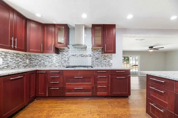 a kitchen with stainless steel appliances granite countertop a refrigerator and a stove