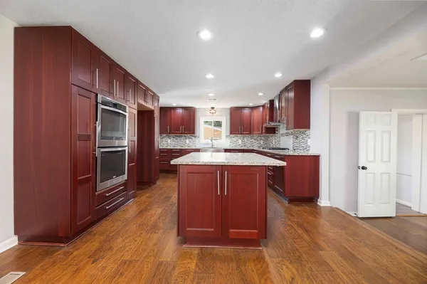 a bathroom with a granite countertop sink mirror toilet and bathtub
