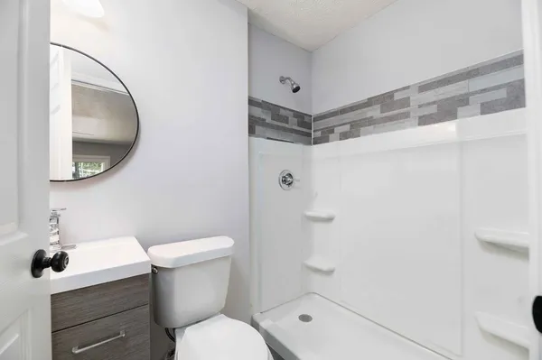 an empty room with a wooden floor and windows