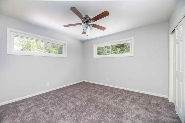 a bathroom with a granite countertop sink and a large mirror
