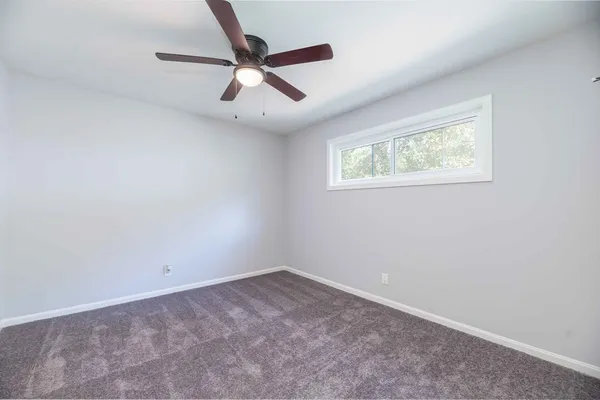 a kitchen with granite countertop a sink a stove and wooden cabinets