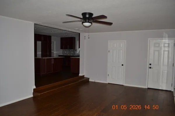 a kitchen with kitchen island a refrigerator and cabinets