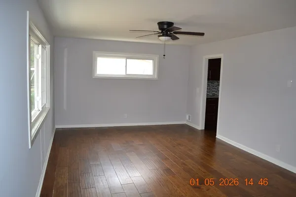 a kitchen with kitchen island granite countertop a refrigerator and a counter top space