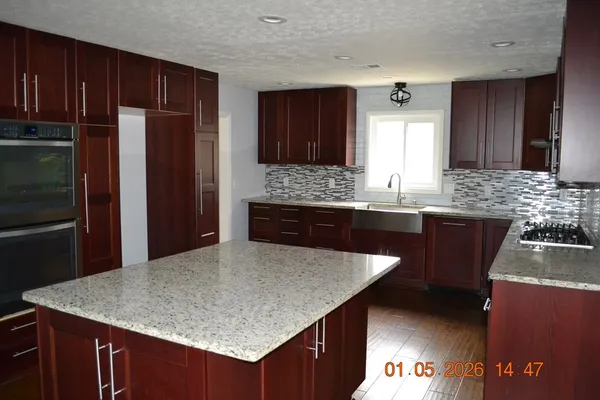 an empty room with a window and a ceiling fan