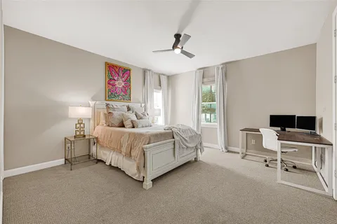 a bedroom with a bed and a desk