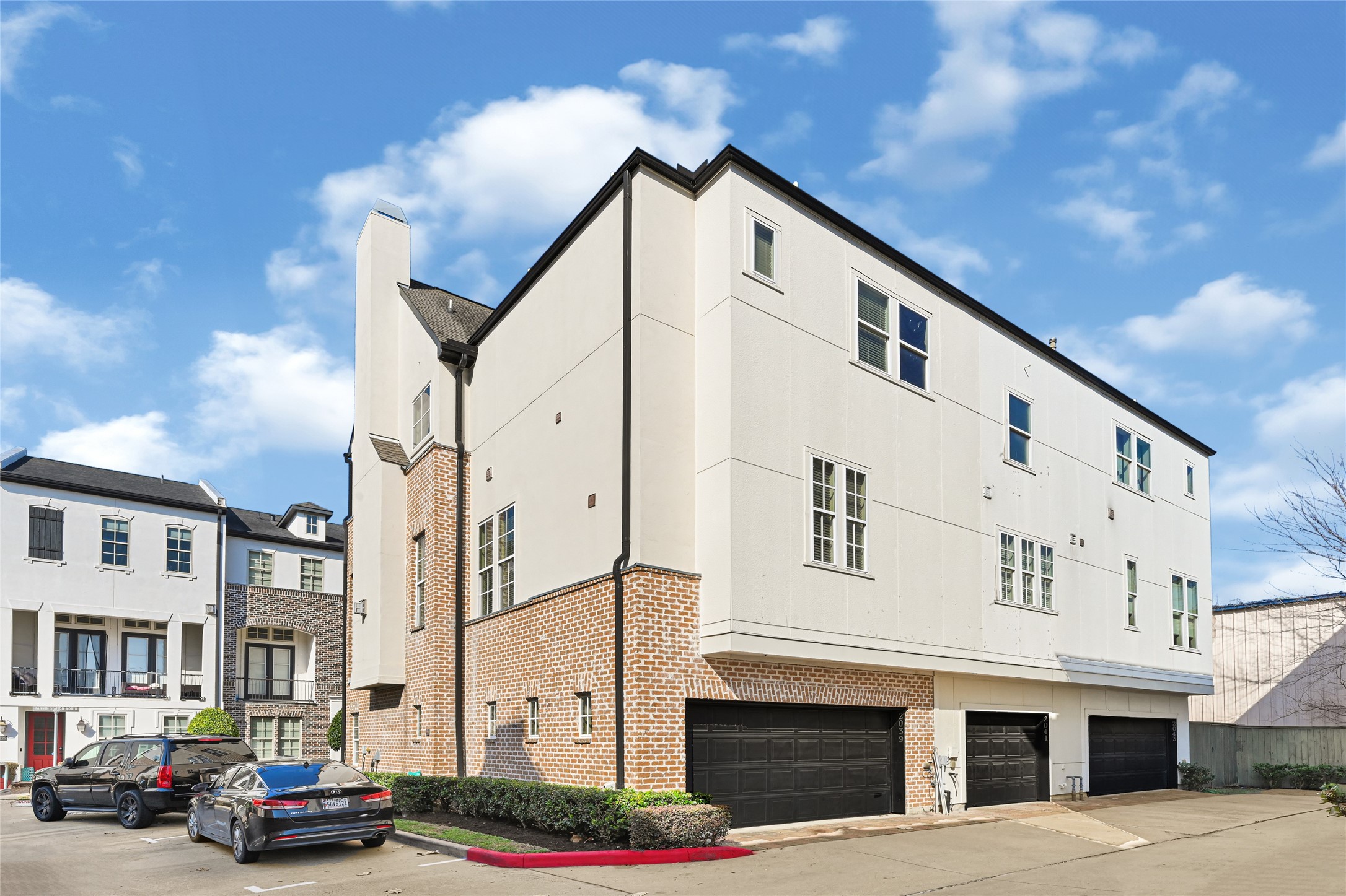 2039 Fannin Station North Houston, TX 77045 - Photo 14 of 25 a front view of a building with lot of cars and trees