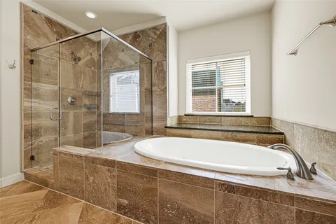 a bathroom with a tub and a shower