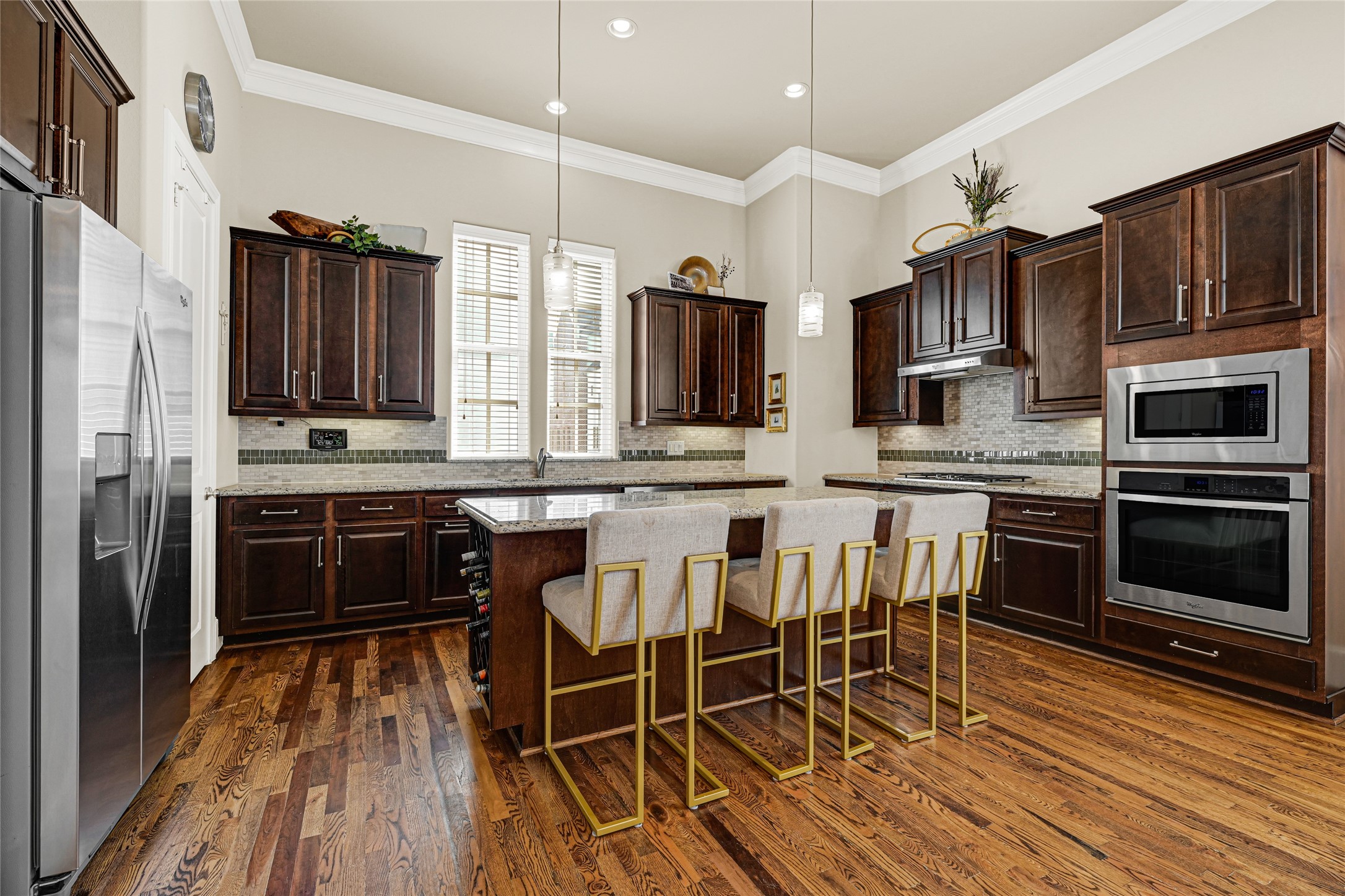 2039 Fannin Station North Houston, TX 77045 - Photo 5 of 25 a kitchen with stainless steel appliances a stove a sink island and a refrigerator