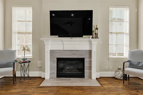 a living room with a fireplace and a flat screen tv