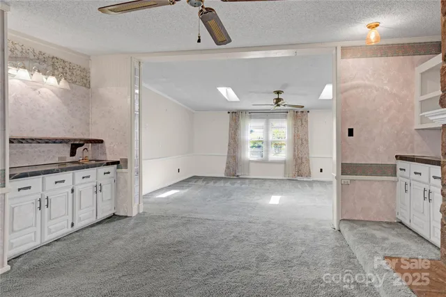 a view of a kitchen with a sink cabinet and a living room