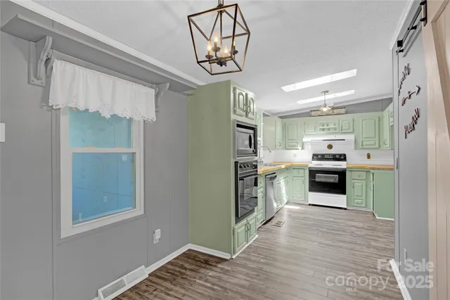 a kitchen with granite countertop a stove and a sink
