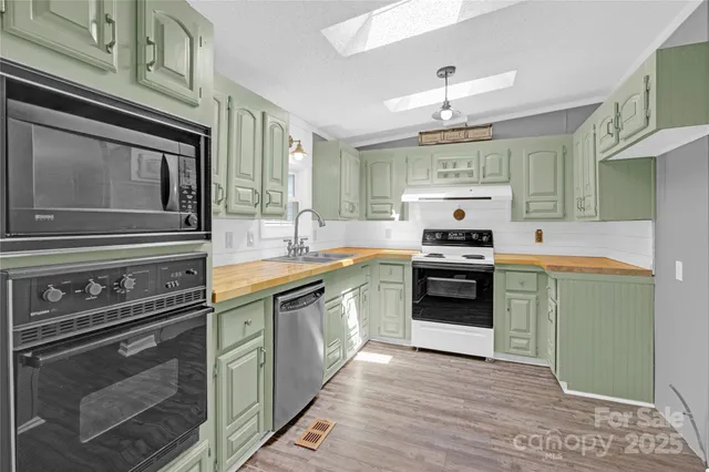 a kitchen with a stove sink and cabinets