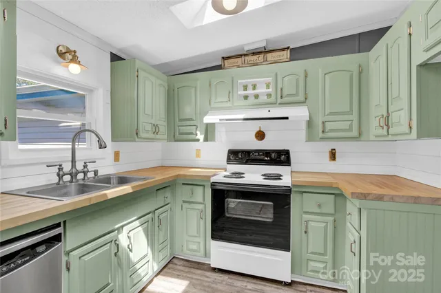 a kitchen with a stove sink and cabinets