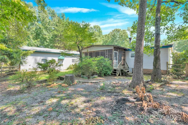 a view of backyard with plants and trees