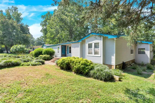 a view of a house with a yard and plants