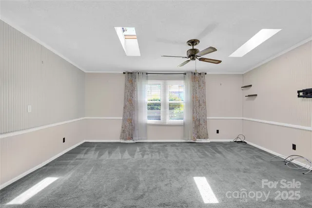 a view of room with a ceiling fan and window