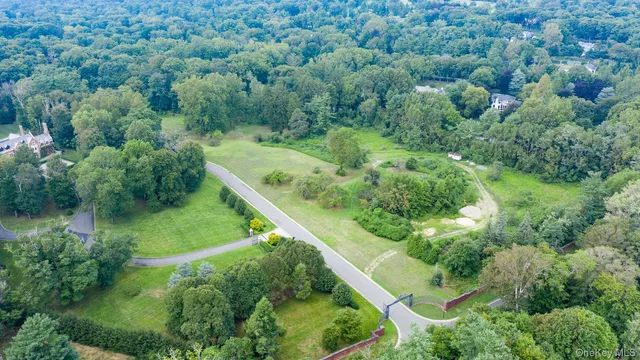 an aerial view of residential house with outdoor space and trees all around