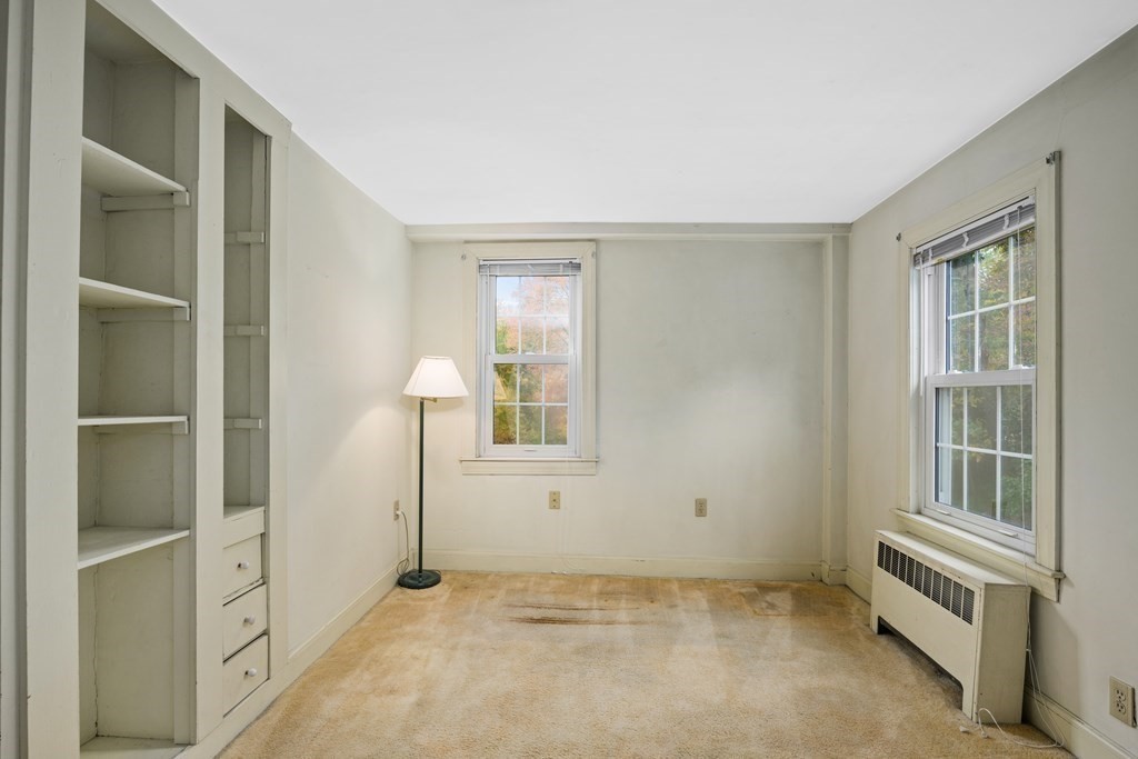 3 Howe Street Ashland, MA 01721 - Photo 20 of 37 a view of an empty room with cabinet and windows
