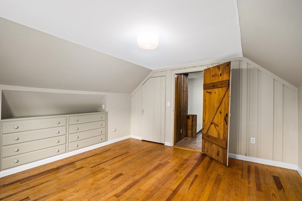 3 Howe Street Ashland, MA 01721 - Photo 25 of 37 a view of a bedroom with wooden floor and cabinet