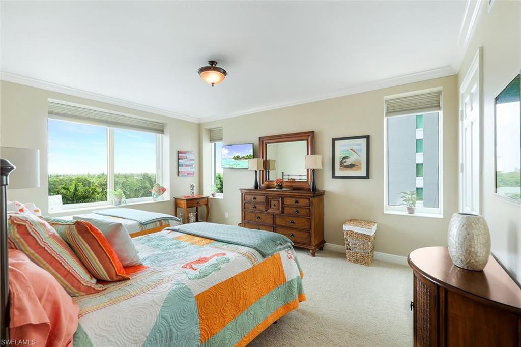275 Indies Way, Unit 605 Naples, FL 34110 - Photo 21 of 41 Carpeted bedroom with ornamental molding