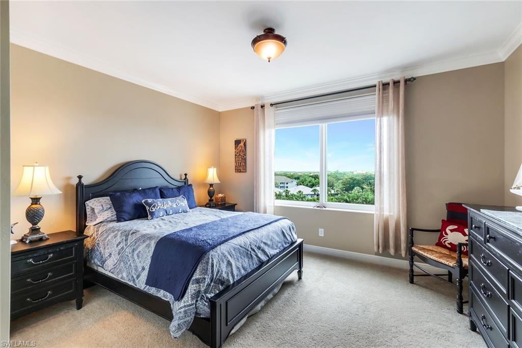 275 Indies Way, Unit 605 Naples, FL 34110 - Photo 23 of 41 Bedroom featuring crown molding and light colored carpet