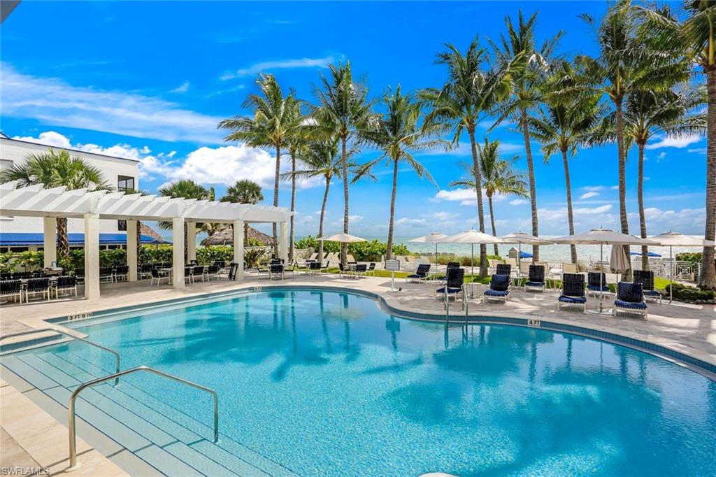 275 Indies Way, Unit 605 Naples, FL 34110 - Photo 33 of 41 Floridian Club swimming pool with a pergola and a patio