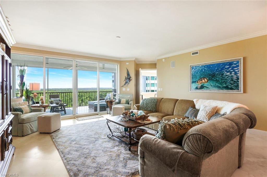 275 Indies Way, Unit 605 Naples, FL 34110 - Photo 8 of 41 Tiled living room featuring ornamental molding