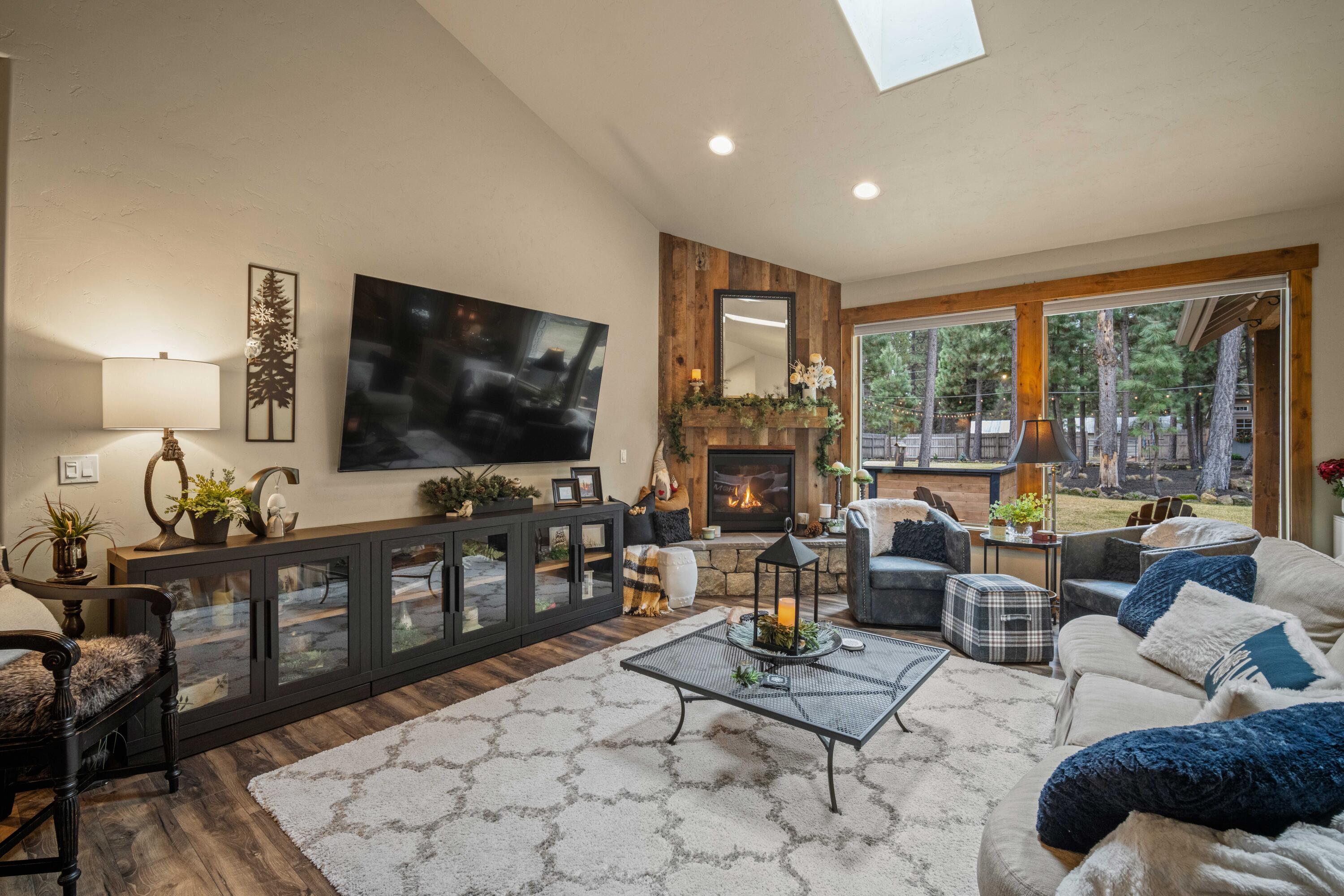 16927 Covina Road Bend, OR 97707 - Photo 1 of 54 Warm and inviting great room with vaulted ceilings, skylights, fireplace, and generous windows overlooking the private backyard oasis.
