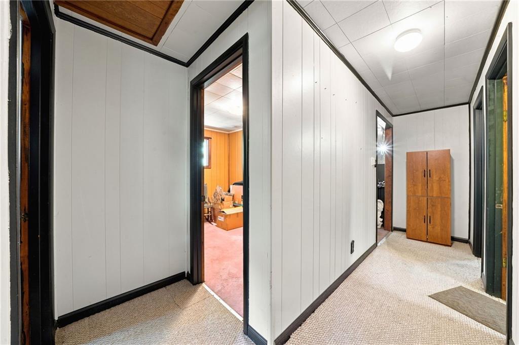 77 Spruce Peak Road Acme, PA 15610 - Photo 16 of 35 a view of a hallway with wooden floor and glass door