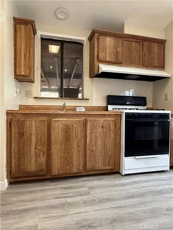 a kitchen with granite countertop a stove and a sink