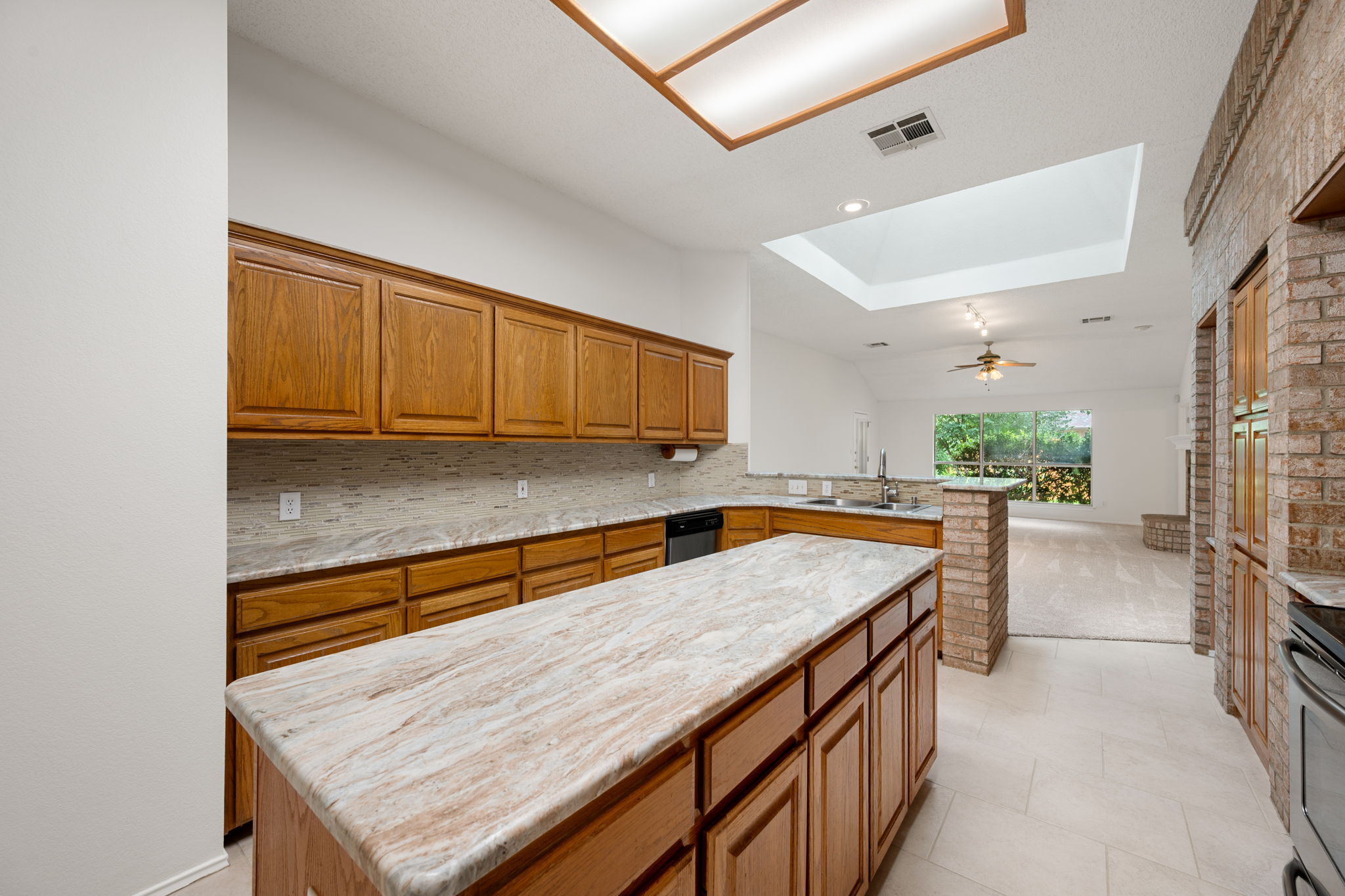 707 Ridge View Drive Leander, TX 78641 - Photo 14 of 40 a kitchen with stainless steel appliances granite countertop wooden cabinets a oven and dishwasher with wooden floor