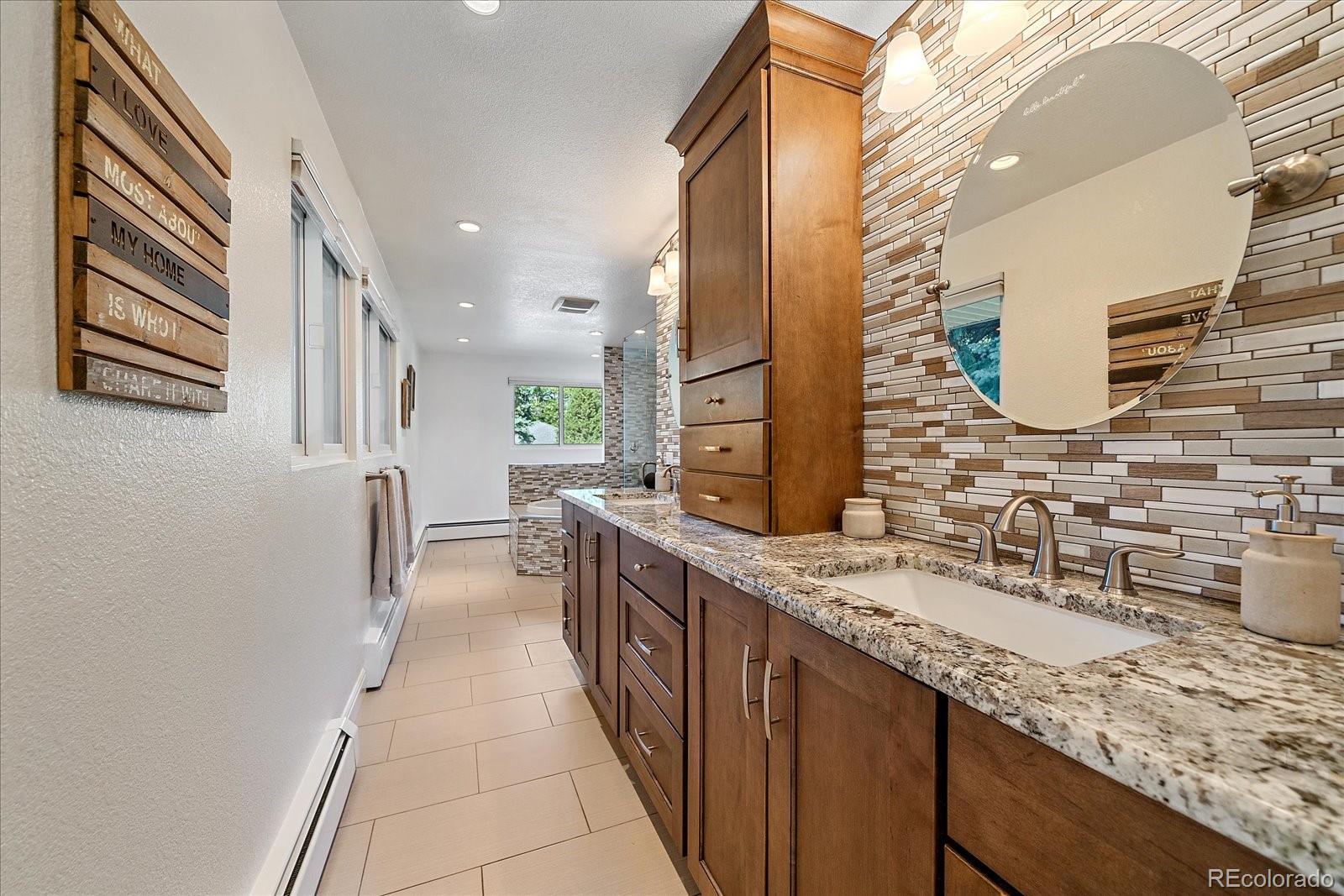930 Reed Court Lakewood, CO 80214 - Photo 12 of 41 a bathroom with a granite countertop double vanity sink and mirror