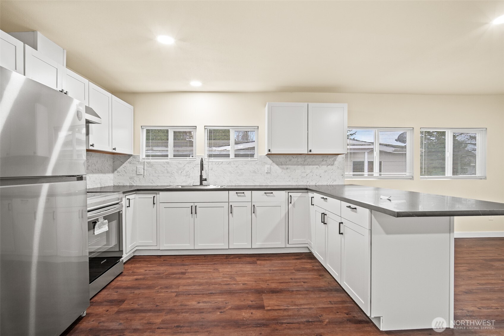 2392 Douglas Road, Unit 4 Ferndale, WA 98248 - Photo 3 of 39 a kitchen with granite countertop a sink stove and refrigerator