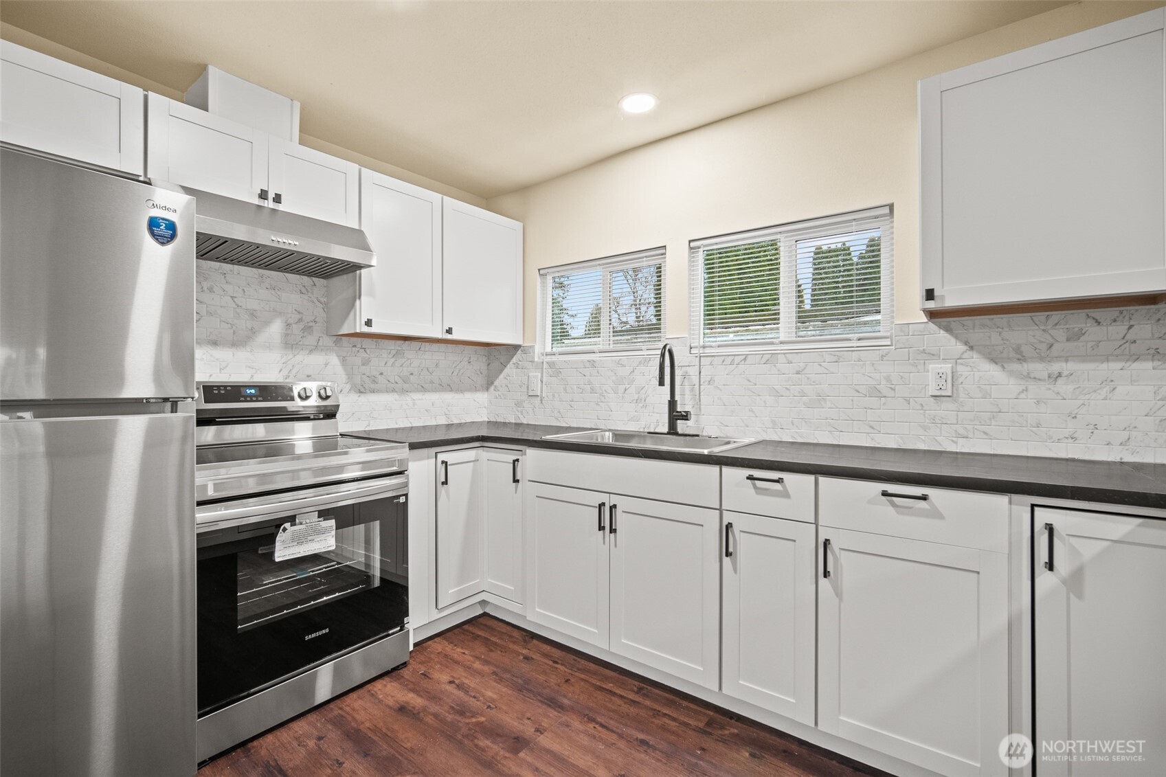2392 Douglas Road, Unit 4 Ferndale, WA 98248 - Photo 4 of 39 a kitchen with granite countertop white cabinets and white appliances